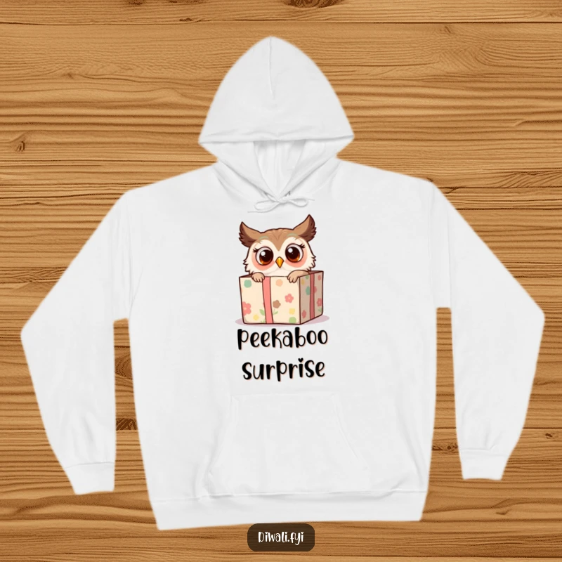 Funny hoodie displaying a surprised owl peeking from a decorated gift box, offering warmth and a touch of whimsical humor.